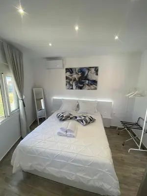 a bedroom with a white bed with towels on it at Angelica Residence in Gennadi