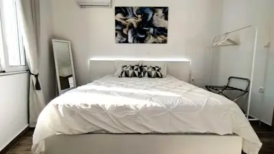 a white bedroom with a large white bed in it at Angelica Residence in Gennadi