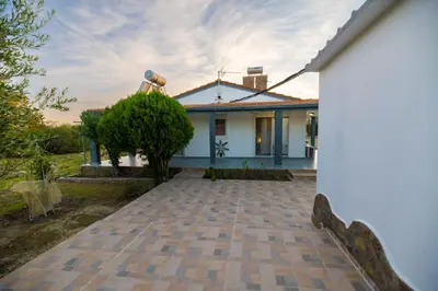 a white house with a brick driveway at Villa Hara Kiotari in Gennadi