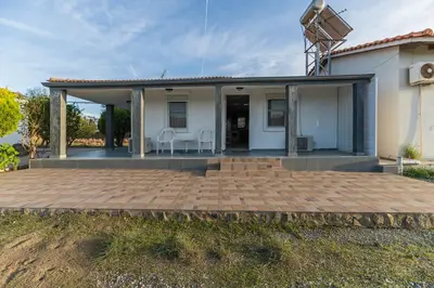 a home with a patio and a house at Villa Hara Kiotari in Gennadi