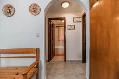 a hallway with a stairway leading to a room with a door at Villa Hara Kiotari in Gennadi
