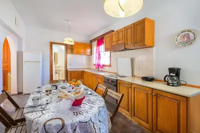 a kitchen with a table with a table cloth at Villas Marianna in Kalavárda