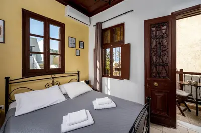 a bedroom with a bed with two towels on it at Muses-Old Town in Rhodes Town