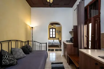 a bedroom with a bed in a room with a mirror at Muses-Old Town in Rhodes Town