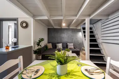 a dining room with a table and a bed at Muses-Old Town in Rhodes Town