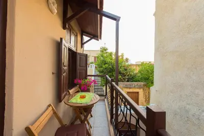 a small balcony with a table on a balcony gmaxwell gmaxwell gmaxwell at Muses-Old Town in Rhodes Town
