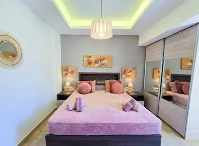 a bedroom with a large bed with purple pillows at Filoxenia City Escape in Rhodes Town