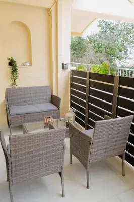 a patio with chairs and a table and a window at Filoxenia City Escape in Rhodes Town