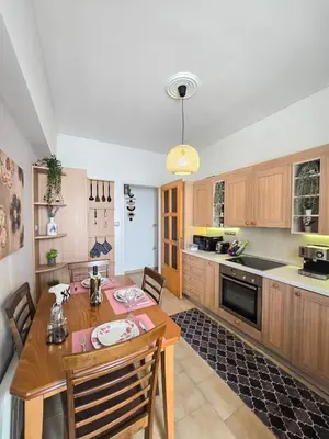 a kitchen with a wooden table and a dining room at Filoxenia City Escape in Rhodes Town