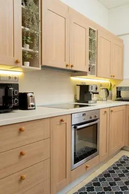 a kitchen with wooden cabinets and an oven at Filoxenia City Escape in Rhodes Town