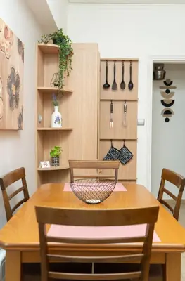 a dining room with a wooden table and some utensils at Filoxenia City Escape in Rhodes Town