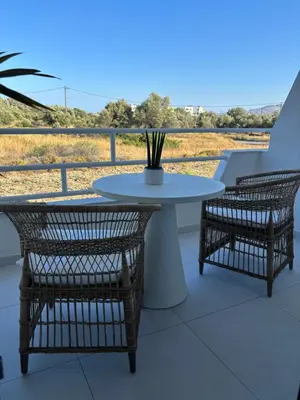 a white table and two chairs and a table and chairs at Agathi Beauty Studios in Haraki