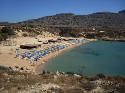 a beach with a bunch of umbrellas and a beach at Agathi Beauty Studios in Haraki
