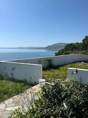 a white fence with a view of the ocean at Amphora Sea View Pefkos in Pefki Rhodes
