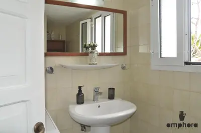 a bathroom with a sink and a mirror at Amphora Sea View Pefkos in Pefki Rhodes