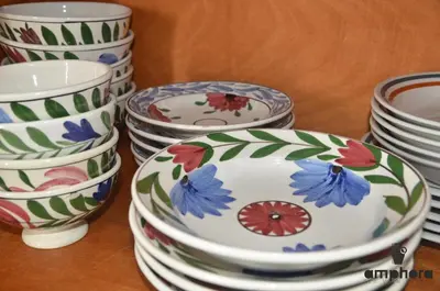 a group of plates and bowls sitting on a table at Amphora Sea View Pefkos in Pefki Rhodes