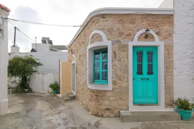 a house with a green door and a window at Kyramarias Village house in Malona Village