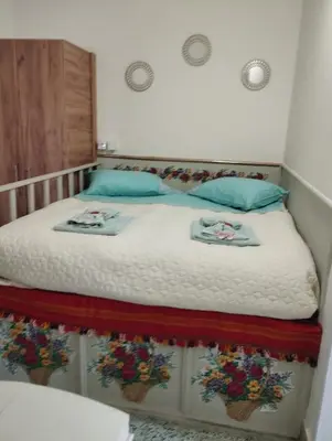 a bedroom with a bed with two towels on it at Kyramarias Village house in Malona Village