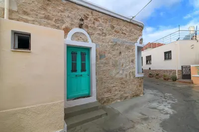 a green door on the side of a building at Kyramarias Village house in Malona Village