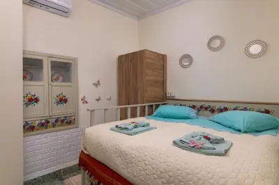 a bedroom with a bed with towels on it at Kyramarias Village house in Malona Village
