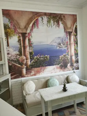 a living room with a large painting on the wall at Kyramarias Village house in Malona Village