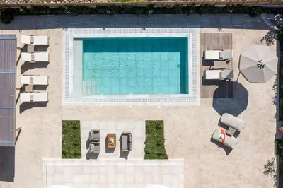 an overhead view of a swimming pool with chaise lounges at Aeon Rhodes - New Villa with private pool in Rhodes Town