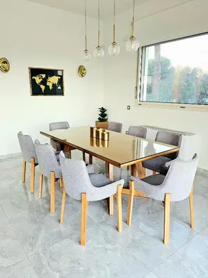 a dining room with a wooden table and chairs at Aeon Rhodes - New Villa with private pool in Rhodes Town