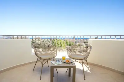 two chairs and a table on a balcony with a view at Aeon Rhodes - New Villa with private pool in Rhodes Town