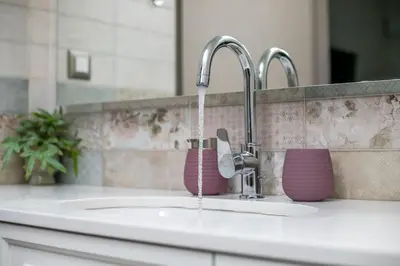 a kitchen sink with two faucets and a sink at Aeon Rhodes - New Villa with private pool in Rhodes Town