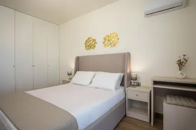 a white bedroom with a bed and a fireplace at Aeon Rhodes - New Villa with private pool in Rhodes Town