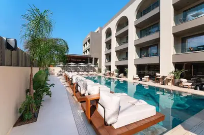 a swimming pool with lounge chairs and a hotel at Alizo Comfort Chic Stay Rhodes - Adults Only in Ixia