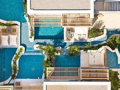 an aerial view of a resort pool with palm trees at Alizo Comfort Chic Stay Rhodes - Adults Only in Ixia