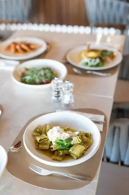 a table with plates of food on a table at Alizo Comfort Chic Stay Rhodes - Adults Only in Ixia
