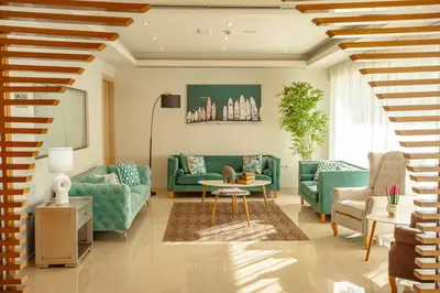 a living room with green couches and a table at Rhodos Horizon Marina - Adults Only in Rhodes Town