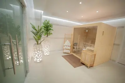 a room with a cabinet and a plant in it at Rhodos Horizon Marina - Adults Only in Rhodes Town