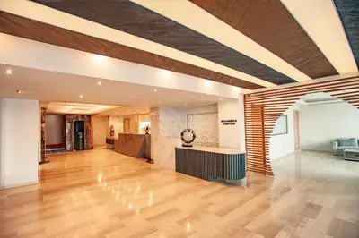 a large living room with wood floors and a ceiling at Rhodos Horizon Marina - Adults Only in Rhodes Town