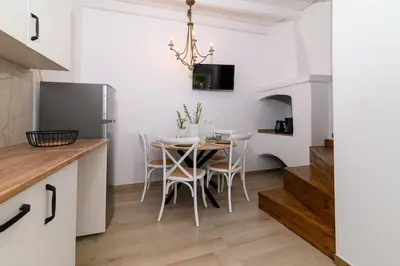 a kitchen and dining room with a table and chairs at Kiki House in Rhodes Town