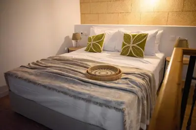 a large bed with a tray on top of it at Kiki House in Rhodes Town