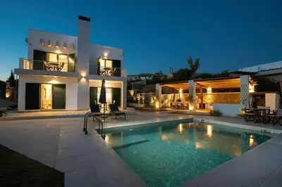 a villa with a swimming pool in front of a house at Villa Kiki, Kiotari in Asklipiḯon