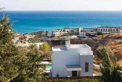 a white house on a hill next to the ocean at Villa Kiki, Kiotari in Asklipiḯon