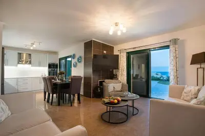 a living room with a couch and a dining room at Villa Kiki, Kiotari in Asklipiḯon