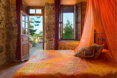 a bedroom with a bed with an orange canopy at Nikos Takis Boutique Fashion hotel in Rhodes Town