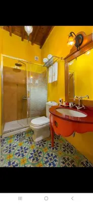 a bathroom with a sink and a shower and a toilet at Nikos Takis Boutique Fashion hotel in Rhodes Town