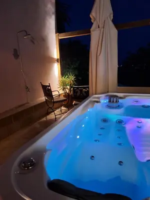 a jacuzzi tub in a room with a window at Nikos Takis Boutique Fashion hotel in Rhodes Town