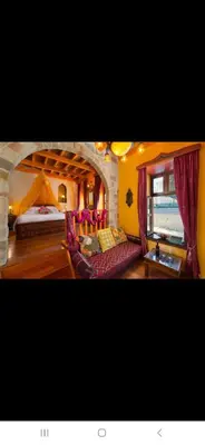 a hotel room with a bed and a couch at Nikos Takis Boutique Fashion hotel in Rhodes Town