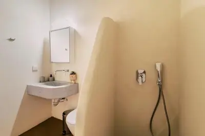 a bathroom with a sink and a toilet at Nora's ixia summer house in Ialyssos
