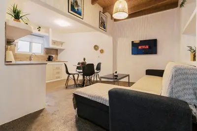 a room with a bed and a kitchen with a table at Nora's ixia summer house in Ialyssos
