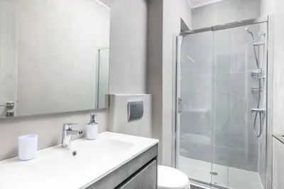 a bathroom with a shower and a sink and a toilet at Villa Anastazia in Koskinou