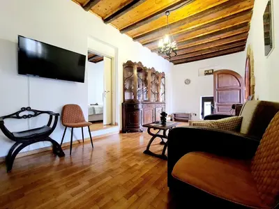 a living room with a couch and a tv on the wall at Shades of Wood Old Town in Rhodes Town