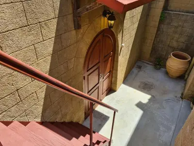 a door on the side of a stone building at Shades of Wood Old Town in Rhodes Town